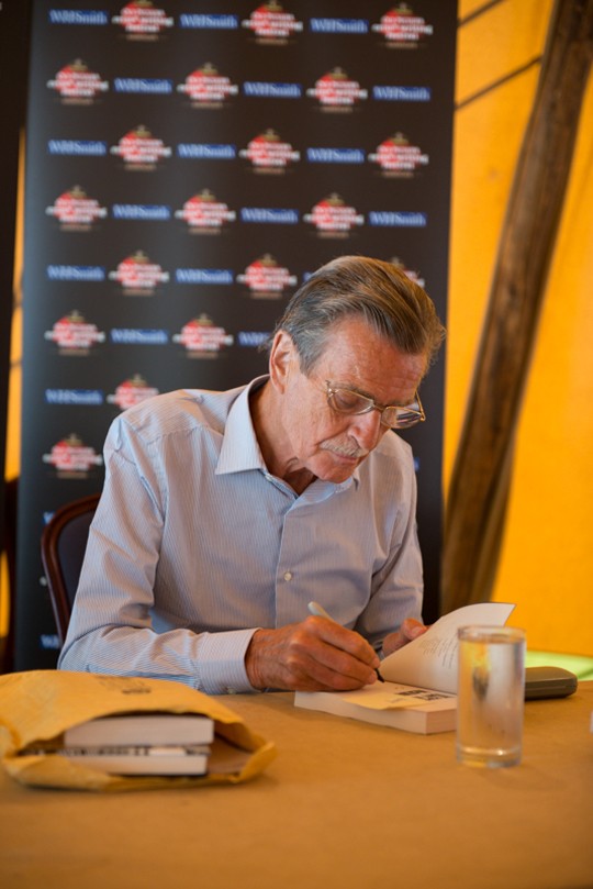 William McIlvanney signs for a fan.